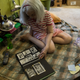 Lillard looks through a photo album on her living room floor. Photo: Jennings Brown for Gizmodo
